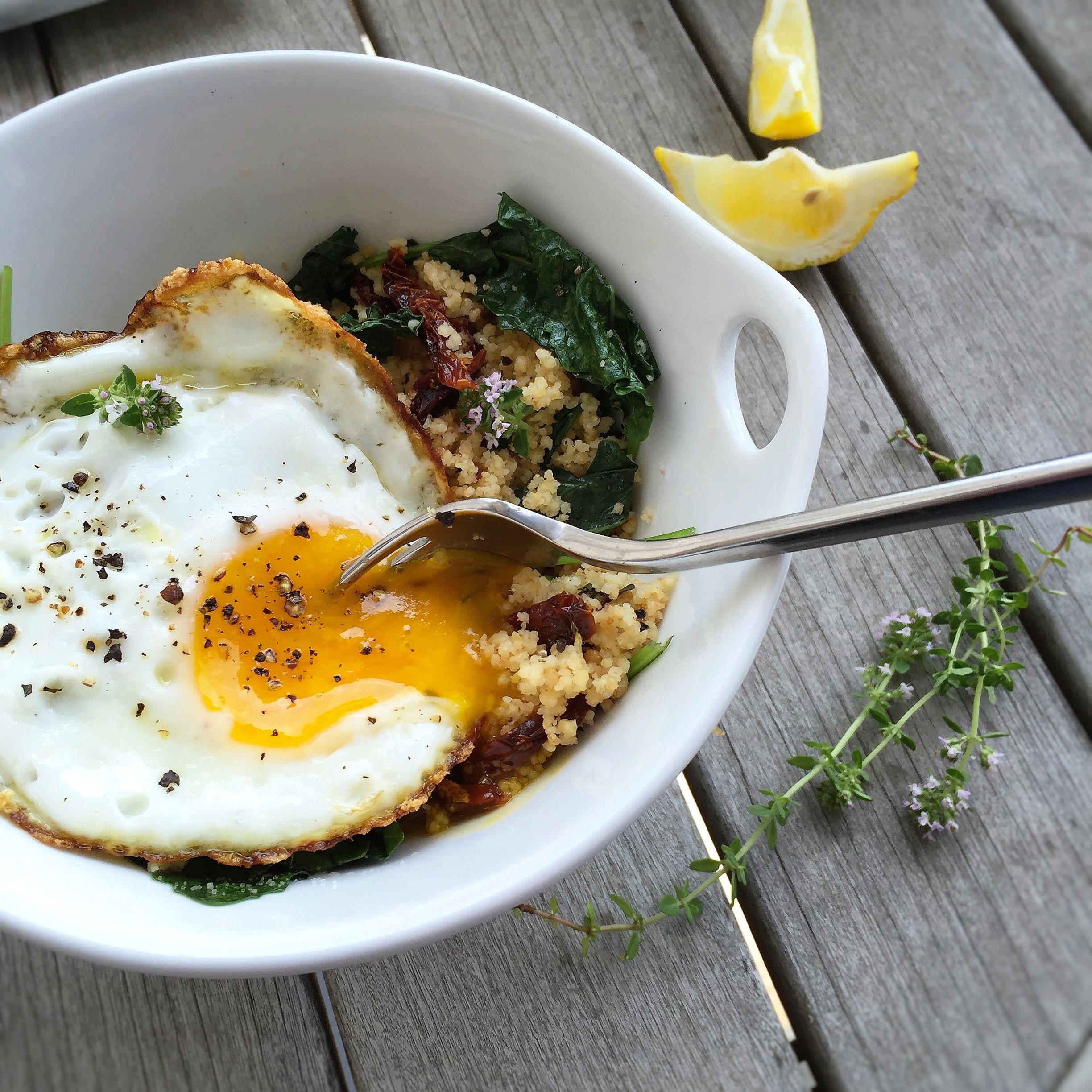 kale and couscous breakfast bowl with egg