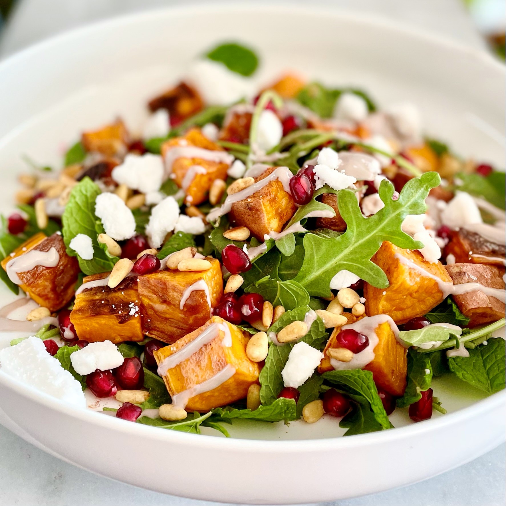 side view of roasted sweet potato salad with pomegranate arils