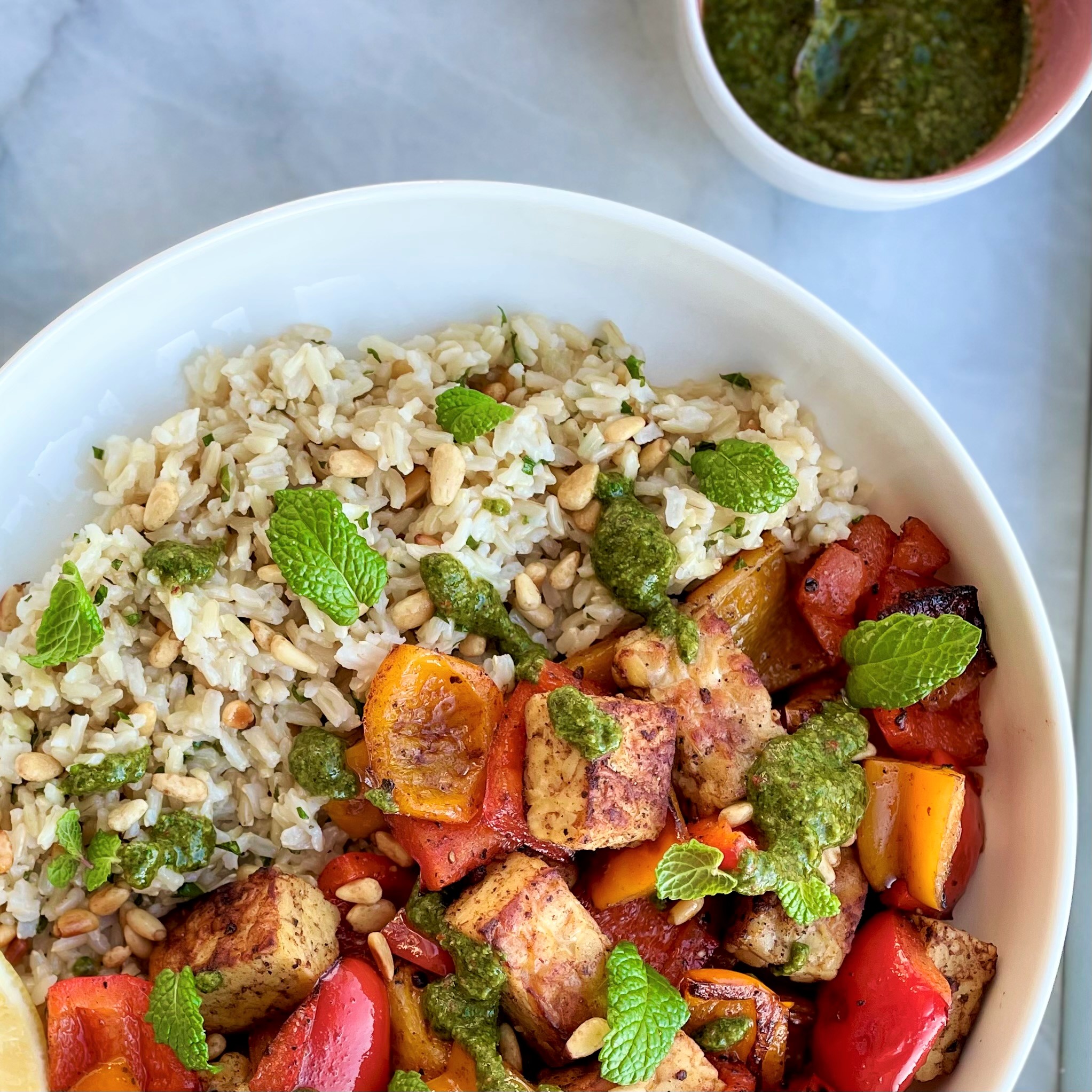 bowl with lebanese tempeh and bell pepper and rice with zhoug