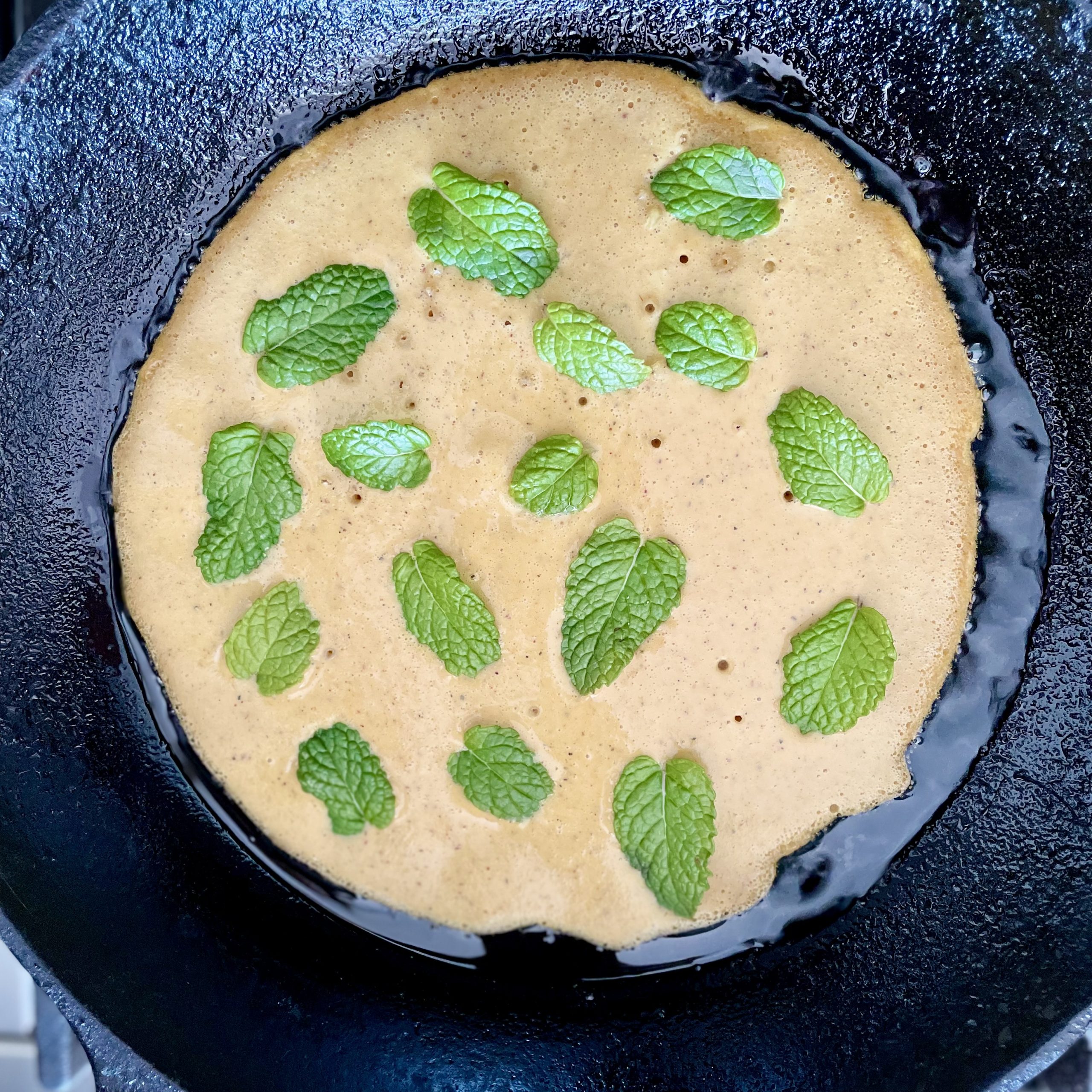 mediterranean plant-based herbed chickpea omelet with mint leaves on top