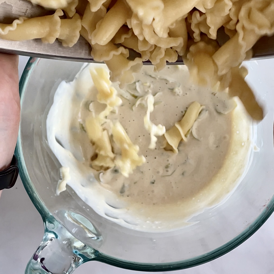 creamy plant-based macaroni salad--adding pasta to dressing