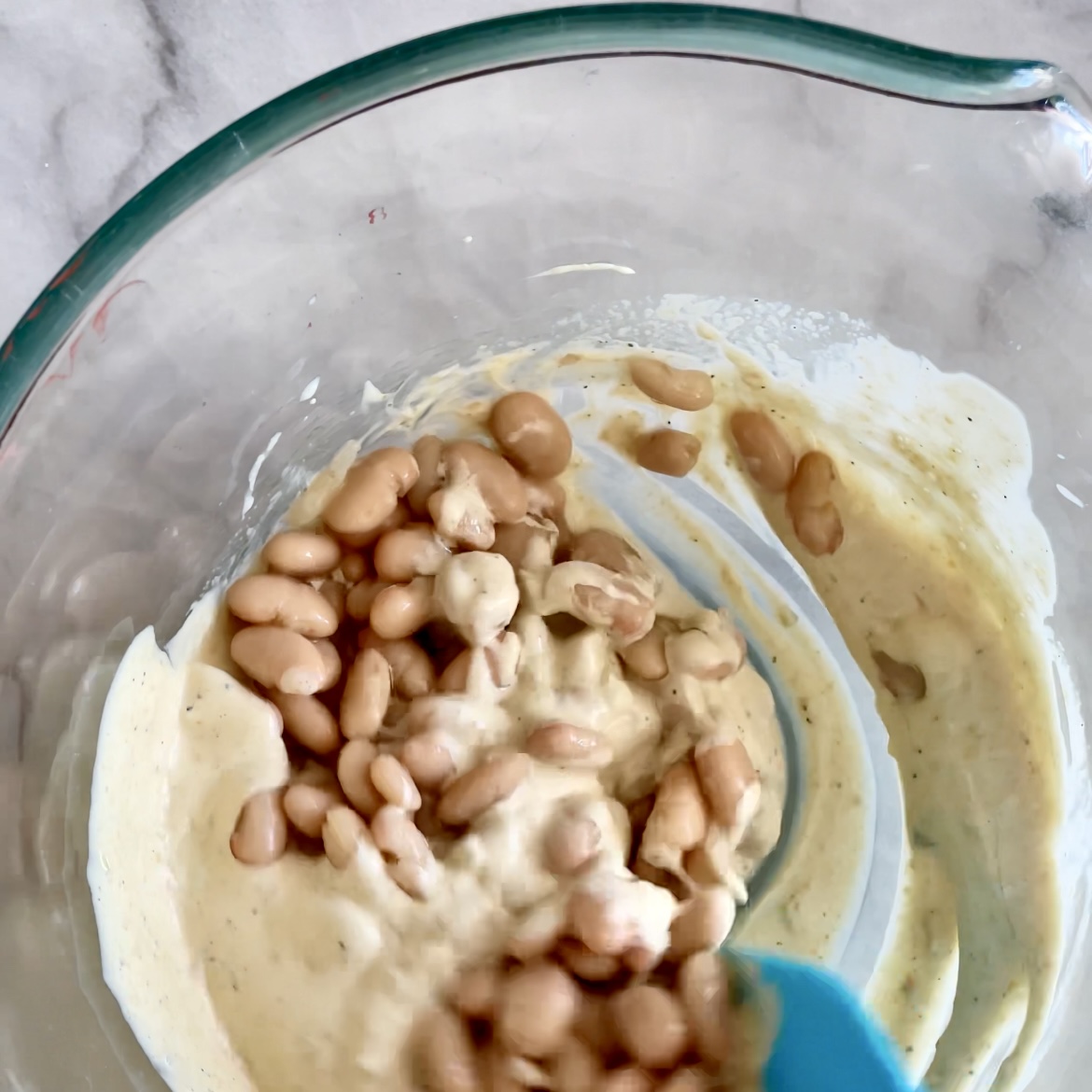 pulse-based egg salad_mixing in white beans