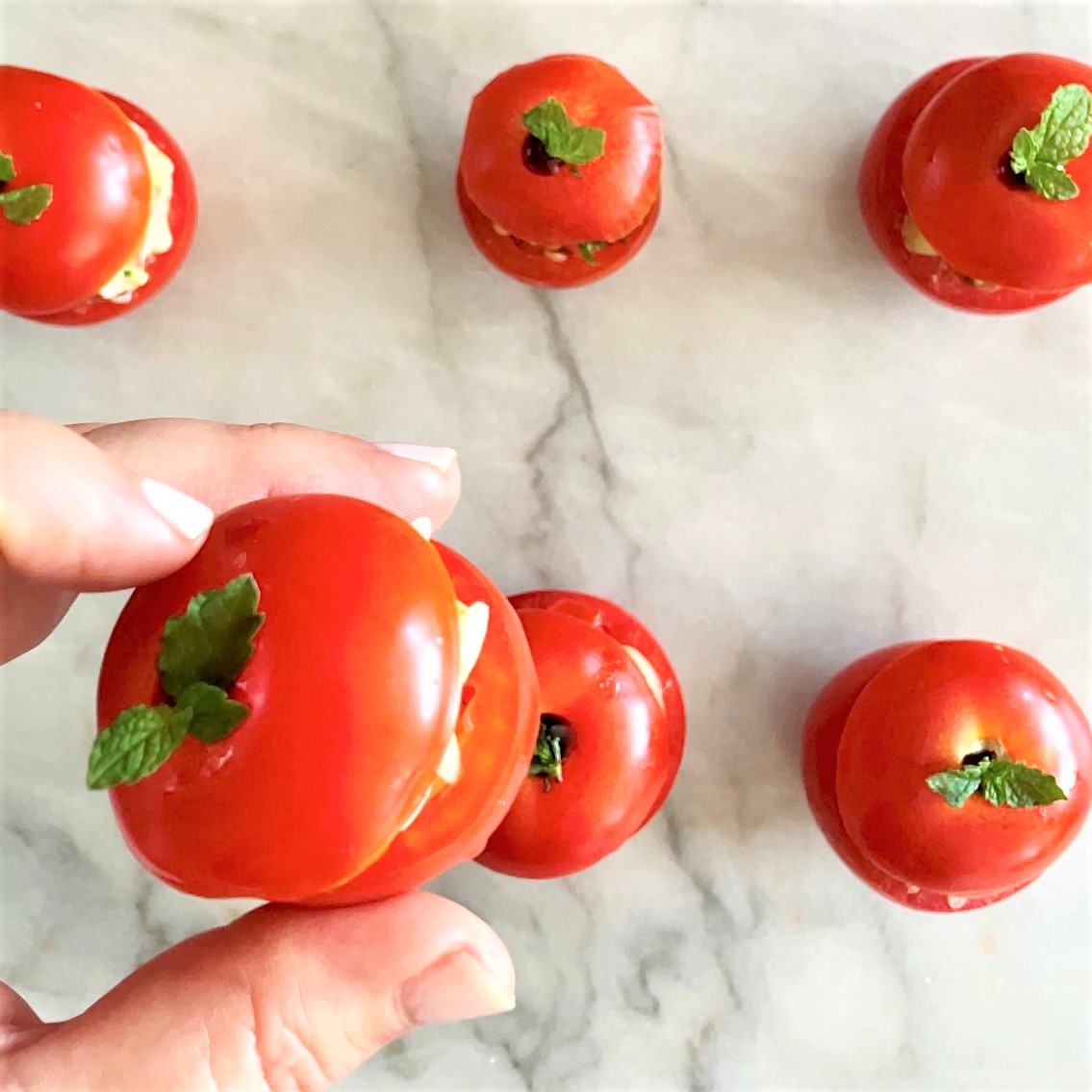 Salad-Stuffed Campari Tomatoes_taking one by hand