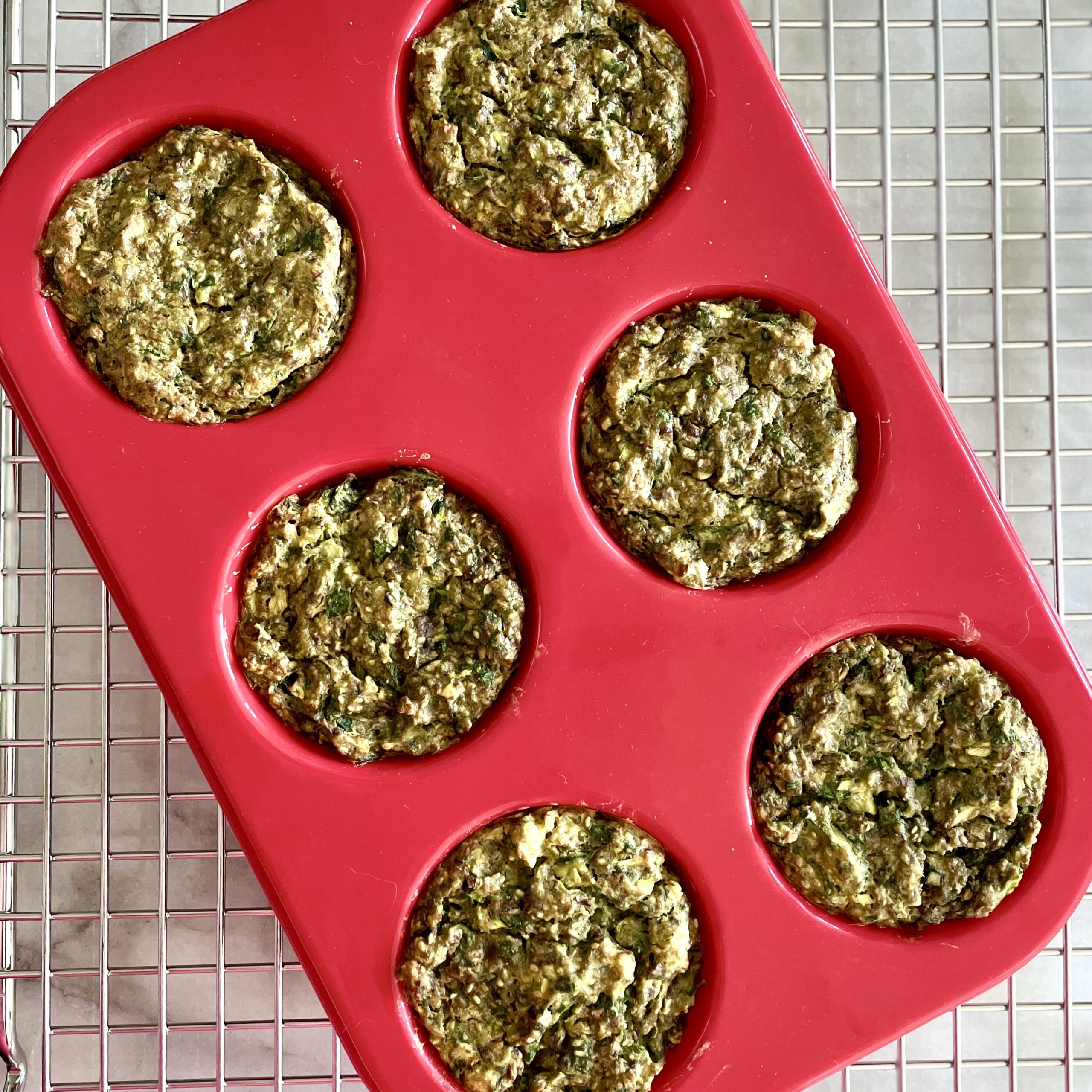hyperbaked earth loaves in a red silicon muffin pan