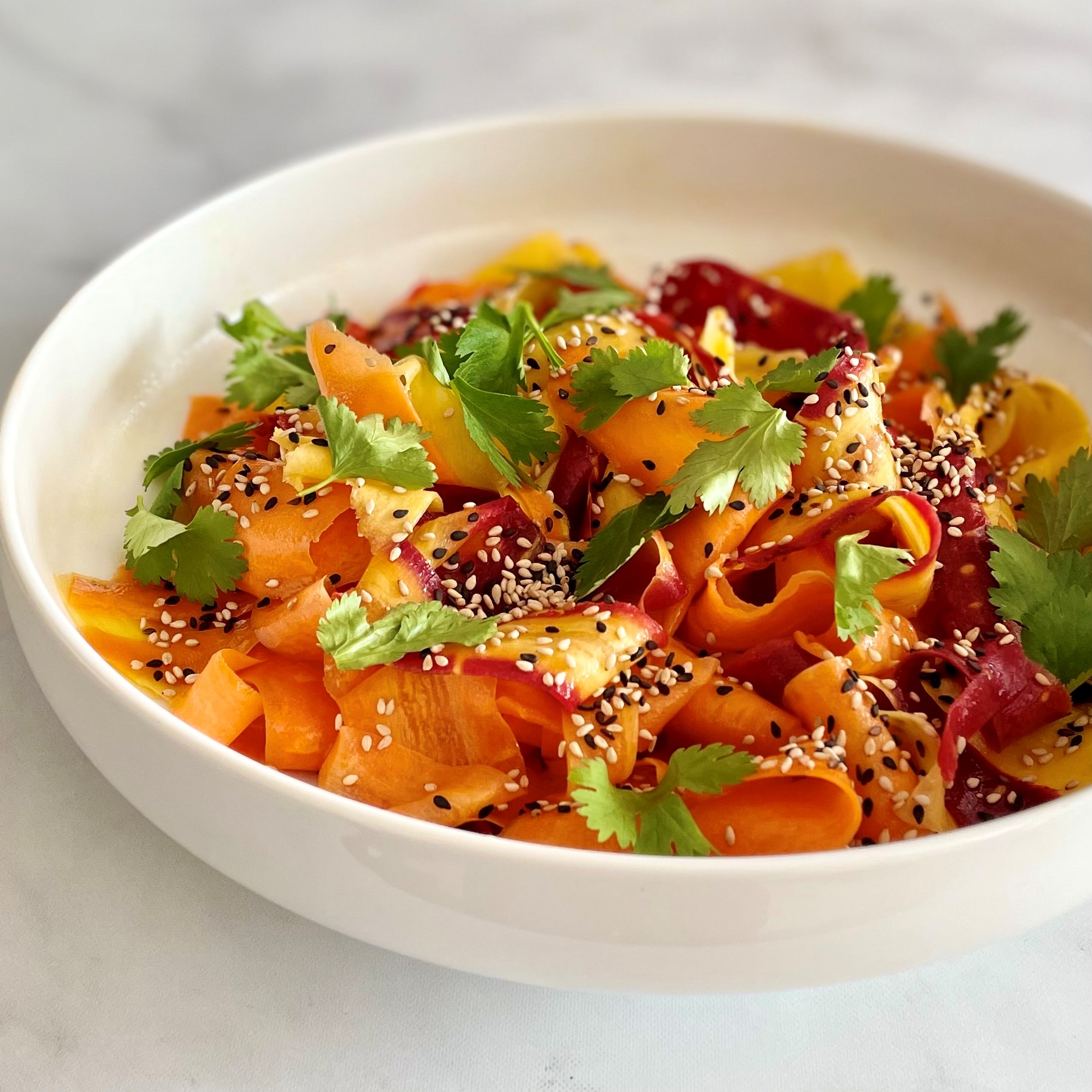 Sesame Carrot Salad_angled photo in a white bowl