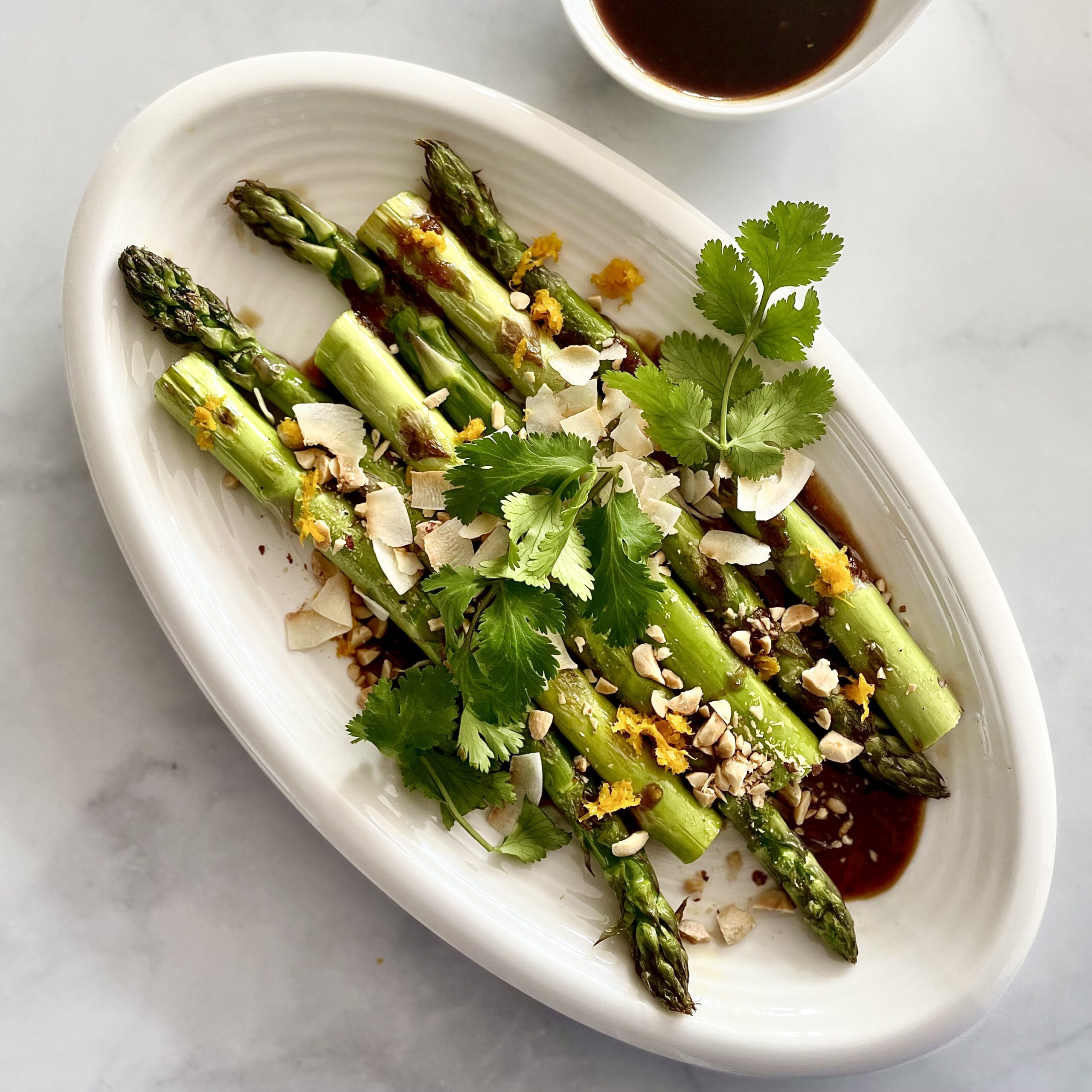 kung pao drizzle sauce over asparagus