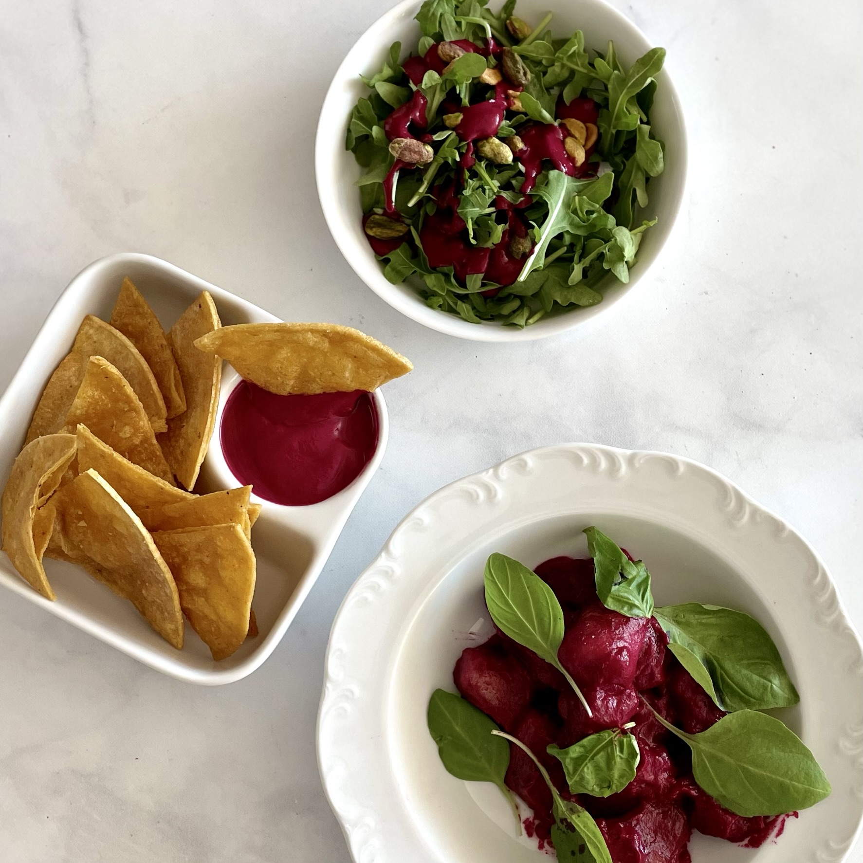 fuchsia fun sauce in three different preparations--with gnocchi, tortilla chips, and salad