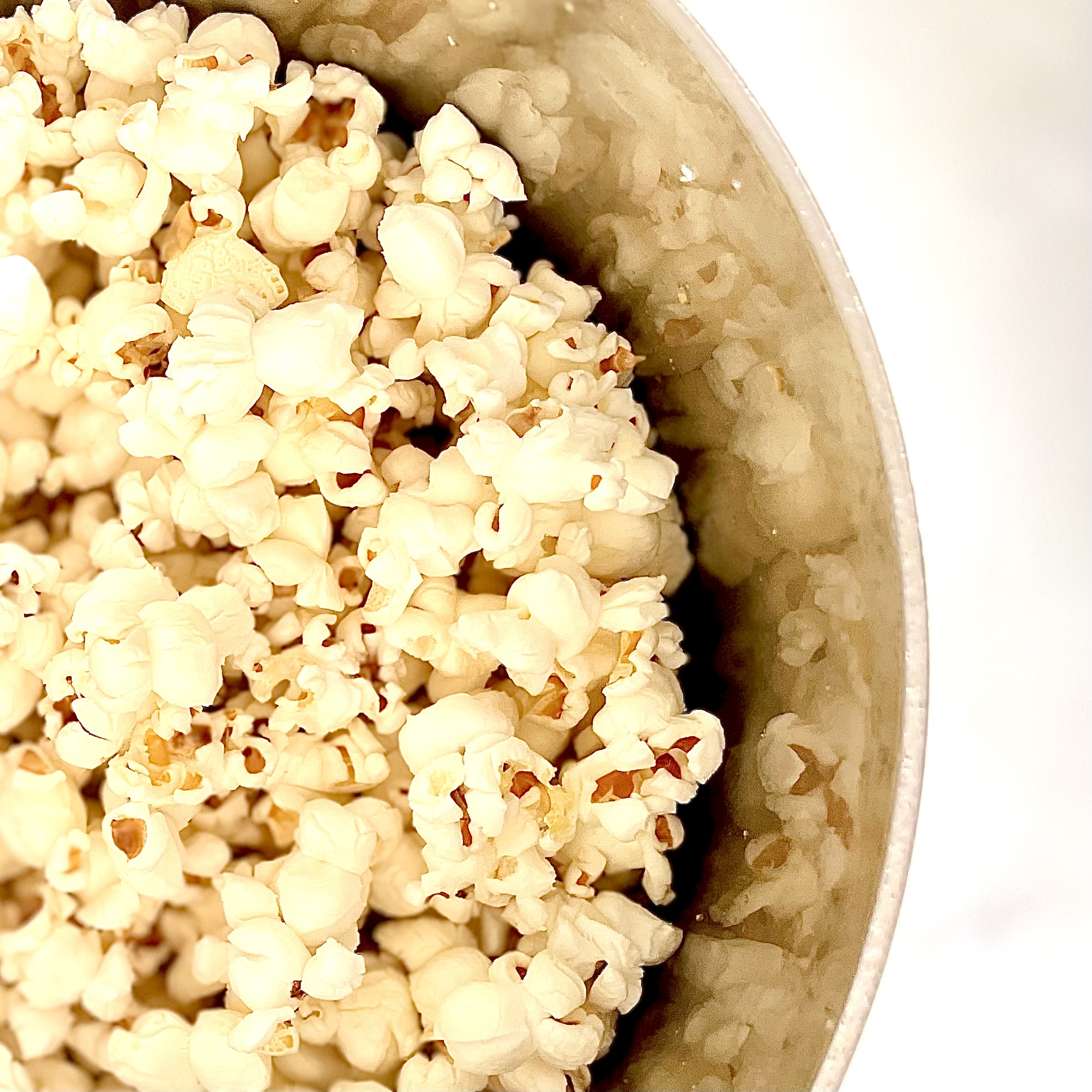 Fresh popped popcorn in stainless steel pan