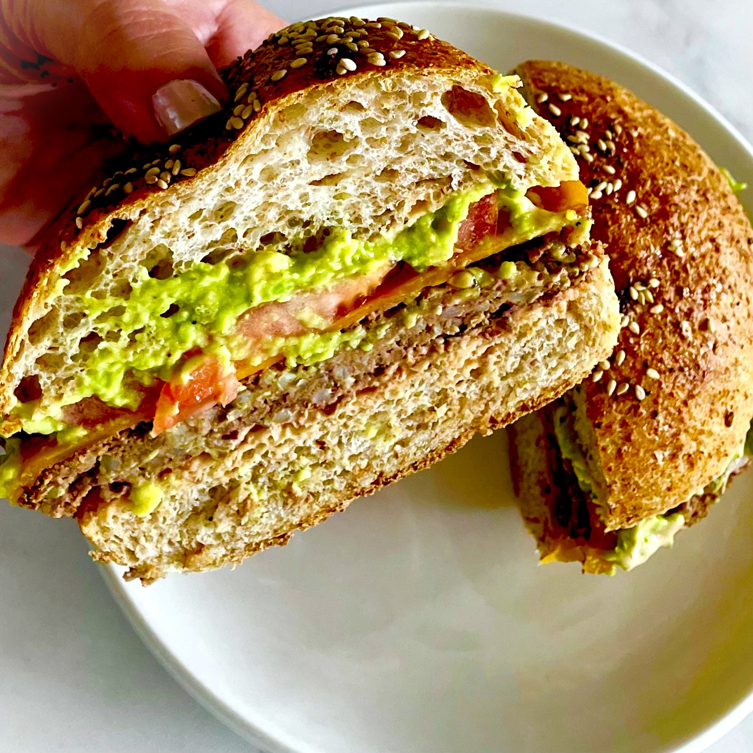 half of a red beans & rice plant-based burger with guacamole