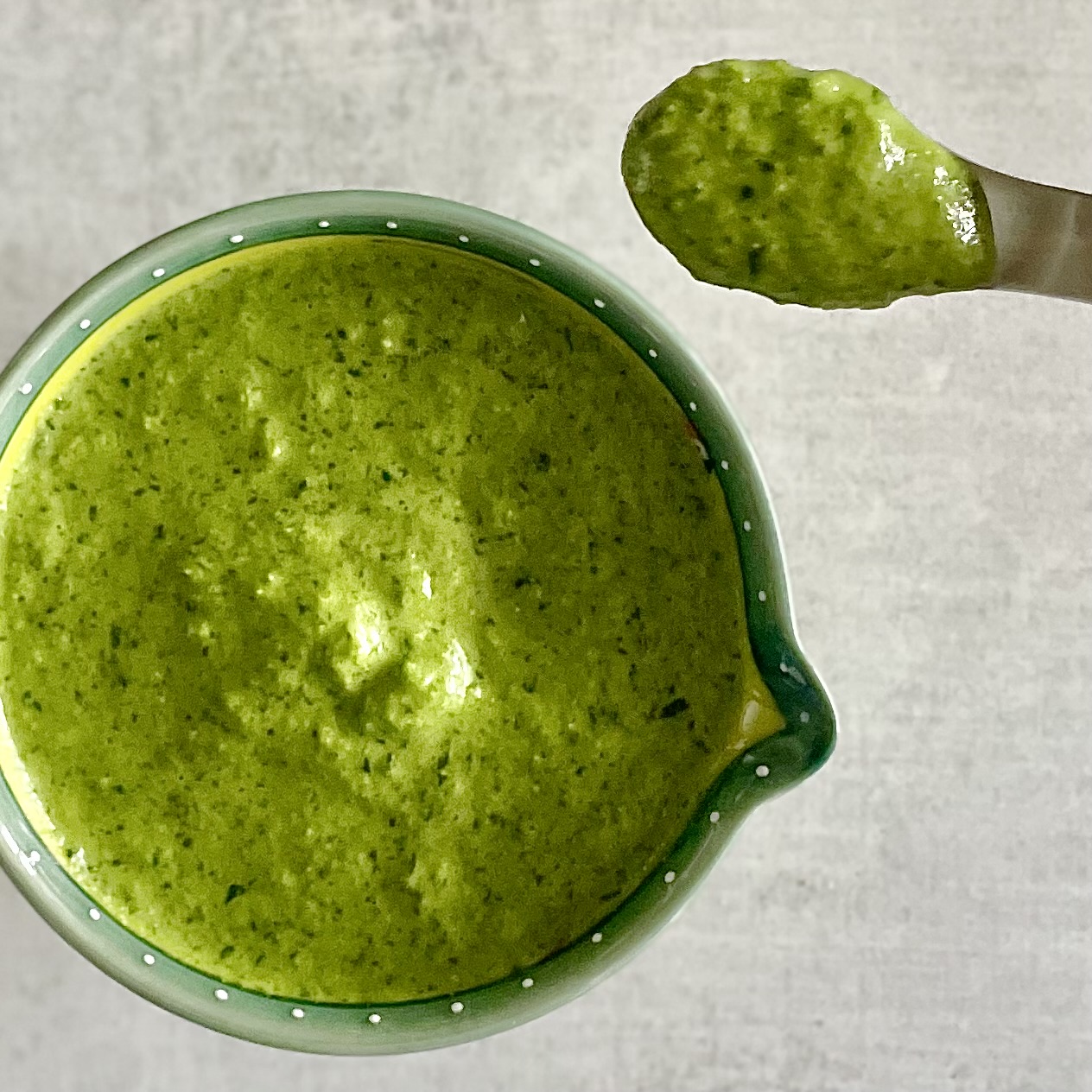 a spoon of hot green sauce