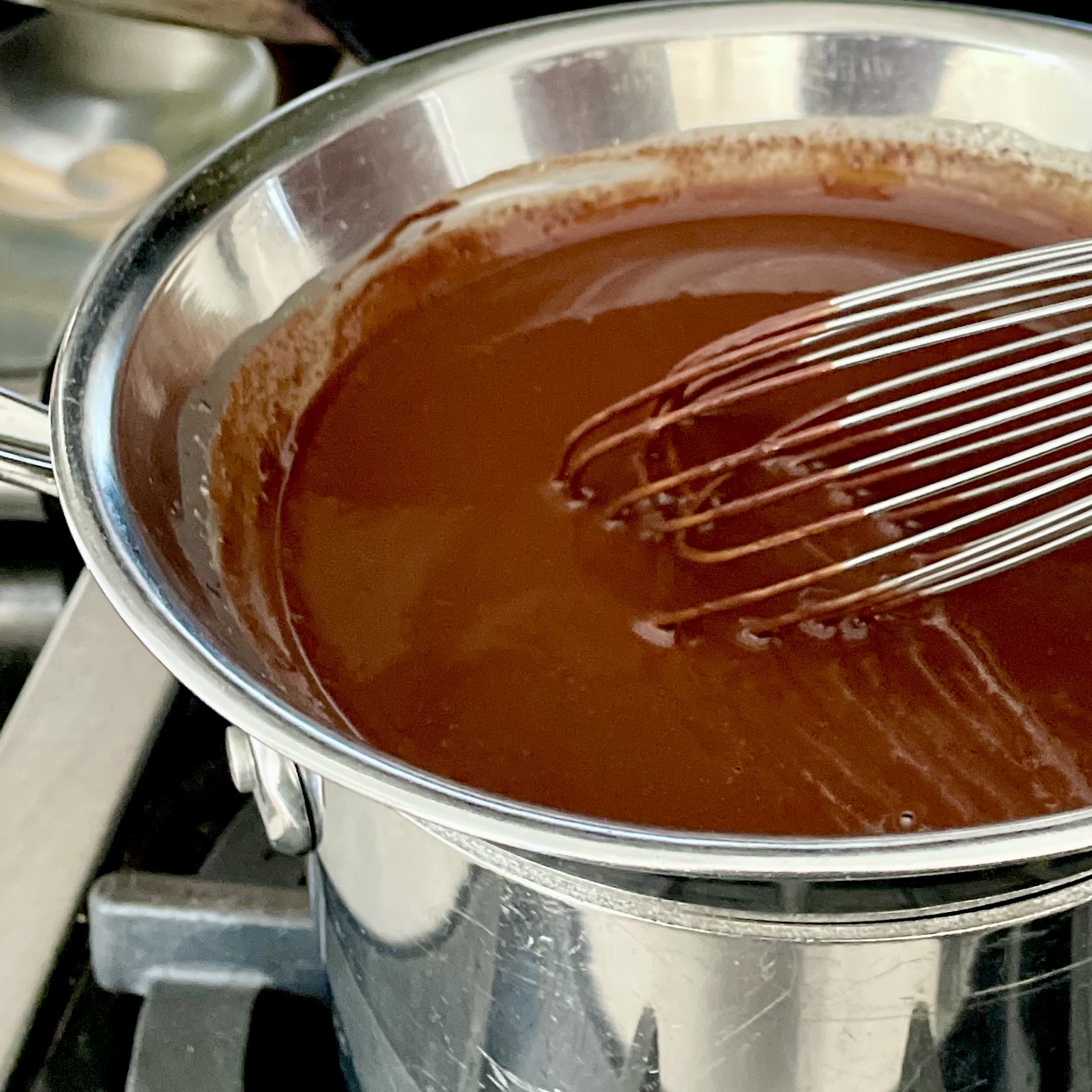 Melting chocolate in a double boiler with a whisk