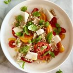big bowl of pasta with heirloom tomatoes, plant-based mozzarella, and basil