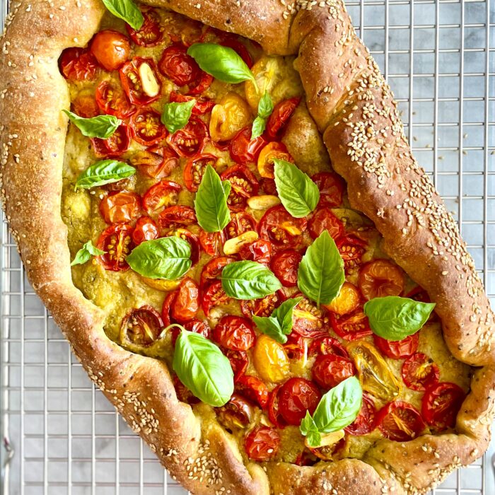 jerusalem bagel-style cherry tomato galette with fresh basil on cooling rack